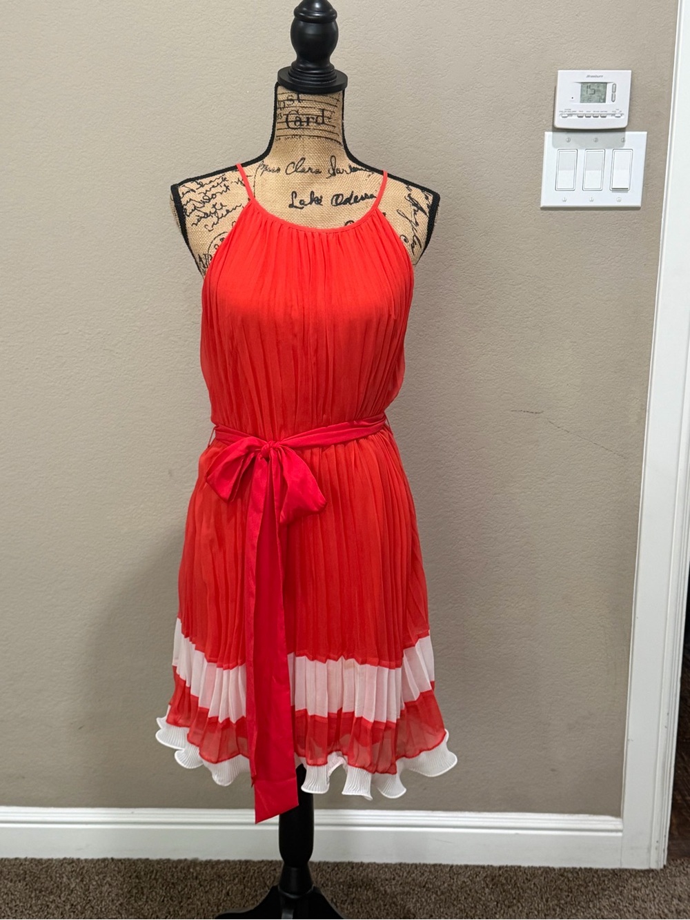 Woman’s Coral Pleated Halter Dress with White Trim and Waist Sash